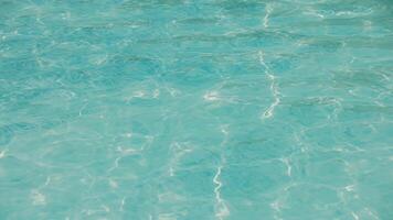 Blue water with ripples on the surface. Defocused, transparent blue, calm water surface texture. video