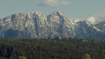 Snow-capped Tatra Mountains Rise Over Lush Green Forests. Giewont Mountain, Poland. video