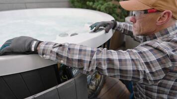 Homeowner Performs Maintenance on Hot Tub in Backyard During Late Afternoon in Autumn video