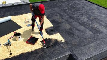 Roof Repair Project in Urban Area With Worker Applying Sealant on Rooftop video