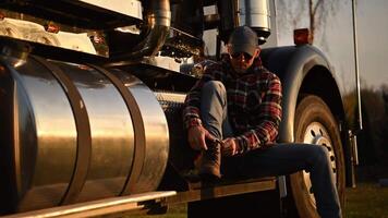 Truck Driver Resting at Sunset After a Long Day of Work in Rural Area video