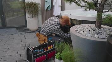 Repair Technician Working on Spa Equipment in a Backyard Setting During Daylight Hours video