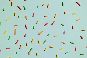 Pattern of Colorful Sprinkles with Hard Shadow on Mint Background, photo