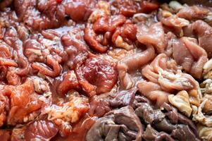 Raw sliced pork with marinated pork, pork belly, pork liver in stall photo