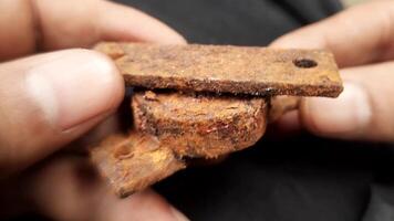 Macro View of Hand Holding Rusted Bearing on Black Background video