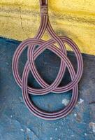 A metal object with a pattern of circles and a knot in the middle. The circles are arranged in a way that they look like they are connected to each other photo