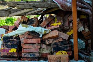 A pile of bricks and a white cloth. The bricks are stacked on top of each other and the cloth is on top of the bricks photo