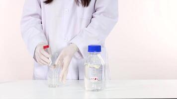 Scientist handling lab equipment for an experiment video