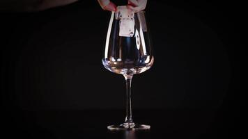 Ice cube placed into an empty glass video