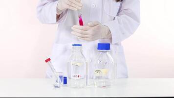 Scientist observes color change in chemical reaction video