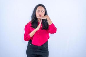a woman in a red shirt and black pants is making a gesture photo