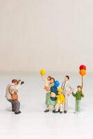 Miniature Family Posing for Photographer with Balloons photo
