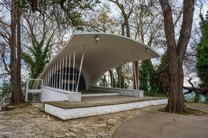 unique architectural structure nestled amongst trees. Stage for outdoor performance photo