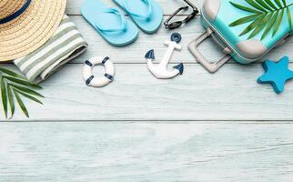 Summer vacation accessories lying on wooden background with copy space photo