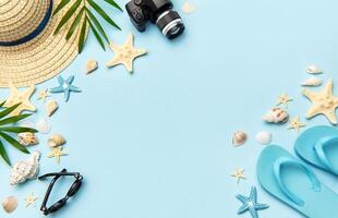 Summer accessories creating frame on light blue background with copy space photo