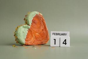 14 February love symbol Delicious fresh croissant topped with Matcha Green Tea flavor Ganache. Creation unique heart shape bakery. Puff pastry holiday love gift present idea Valentine's day. Copy space photo