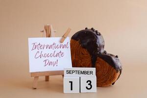 Calendar date 13 September international chocolate day greeting card Delicious fresh croissant topped with colorful flavor Ganache. Creation unique heart shape bakery. Puff pastry holiday love gift present idea. Copy space photo