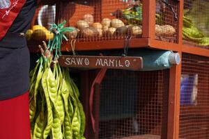 Sign of sawo manilo means sapodilla manillo in itinerant fruit traders who sell sapodilla and petai fruit use motorbikes photo