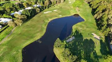 Drone captures sweeping views of a lush golf course in Gold Coast, Australia, highlighting fairways, greens, and surrounding nature video