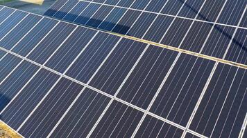 Aerial view of solar panels in a sunlit farm setting, capturing renewable energy efficiently video