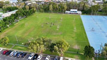 Drone captures netball courts and fields at Gold Coast sporting complex. Bright daylight, vibrant greenery, and active sports scene video