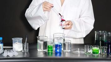 Scientist conduct experiment with colorful liquids video