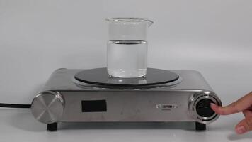 Sequential heating of water in a beaker on a stove video