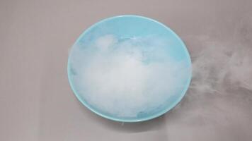 Dry ice evaporating in water creating fog video