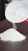 Woman Adds Flour On The Table For The Preparation Of A Typical Dessert video