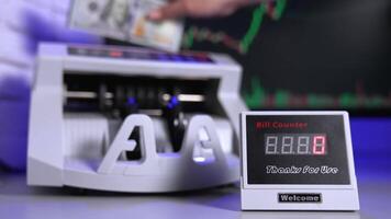 Modern cash counter machine on the table. Hand is putting a large amount of paper money into electronic machine for counting operation. video