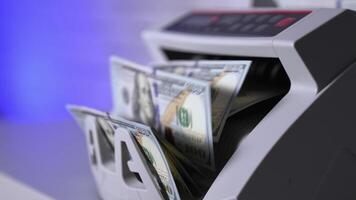 Money counting equipment for paper money calculation. Automatic mechanism for bank financial operations. Currency exchange of one hundred usd. Closeup currency counting machine counting dollar video
