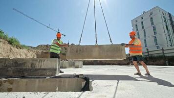Construction Workers Installing Concrete Slab with Crane, Heavy Lifting Operation on Urban Building Site video