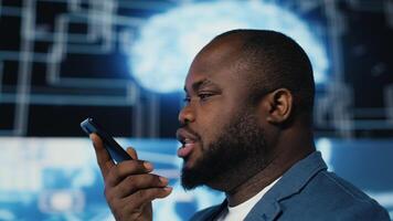 African american expert engaged in a phone call chat about machine learning, surrounded by a virtual interface showcasing AI brain data visualization and high tech innovation. Camera B. video