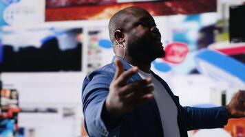 African american host at digital event engages the audience with insights on social media trends, e commerce and engagement using apps or web platforms. Real time data visualization. Camera B. video