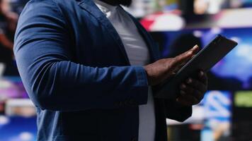 Black social network user oversees dashboards with dynamic interfaces showcasing social media and networking, highlighting the importance of online engagement and global connection. Camera B. video