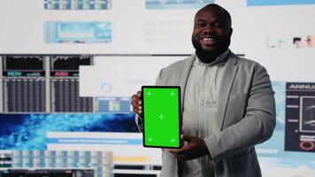 Black business expert looks at device with copy space for analysis, reviewing monthly reports and infographics for company development. Performance metrics for growth, forecasting. Camera B. video