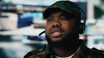 African american army personnel transmitting information on headset, gathering crucial enemy position data from satellite surveillance footage. Territorial guidance for a mission. Camera B. video