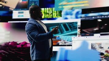 Smiling user navigating through online content and mobile apps, surrounded by visual elements of social engagement, tech communication and modern digital platforms on smartphone. Camera B. video