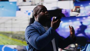 Smiling user answering a smartphone call next to mobile apps on screen, surrounded by visual elements of social engagement, and web communication. Connecting via social networking. Camera B. video