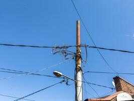 Electric grid in Georgia. Concrete utility poles in Tbilisi city. Step down transformers photo