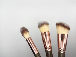 Makeup cosmetic brushes collection on white background with strong shadows background. Top view. Flat lay, knolling concept photo