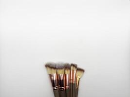 Overhead shot of makeup brushes set isolated on white background photo