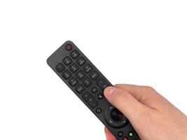 White male hand on white background presses buttons on remote control, man switches TV channels with remote control, for banners, for TV advertising. Copy space, flay lay, top view. photo
