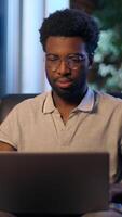 African American guy student business man in night office businessman entrepreneur thoughtful male worker overtime evening laptop online working studying young designer programmer gamer computer using video