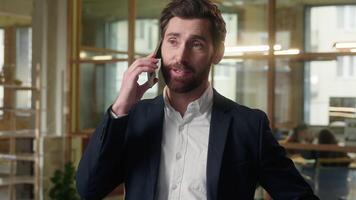 Caucasian businessman talking mobile phone in office smiling guy business man negotiate speaking cellphone male middle-aged manager job talk call smartphone professional conversation consulting client video
