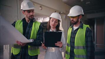 Caucasian colleagues building teamwork builders speak blueprint in construction woman controller architect planning draft architectural men constructing project technicians handymen cooperation work video