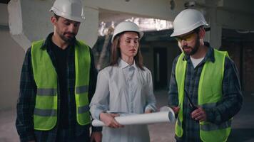 Professional Caucasian colleagues builders discuss build draft in construction disappointed woman supervisor talking project blueprint trouble men contractors electricians engineers argument conflict video