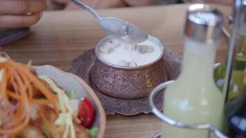 Enjoying a traditional creamy yogurt soup and fresh salad video