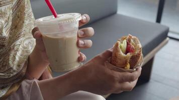 Enjoying a refreshing drink and tasty sandwich at a cafe video