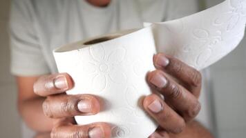 Holding a roll of paper towels in a bright setting video